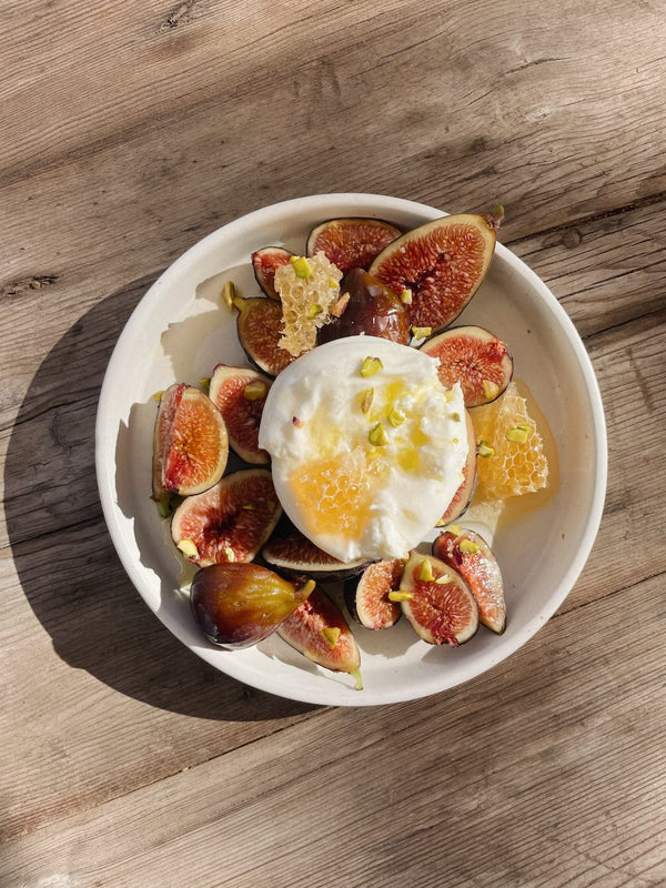 Sliced figs, topped with burrata cheese, olive oil and flake salt.