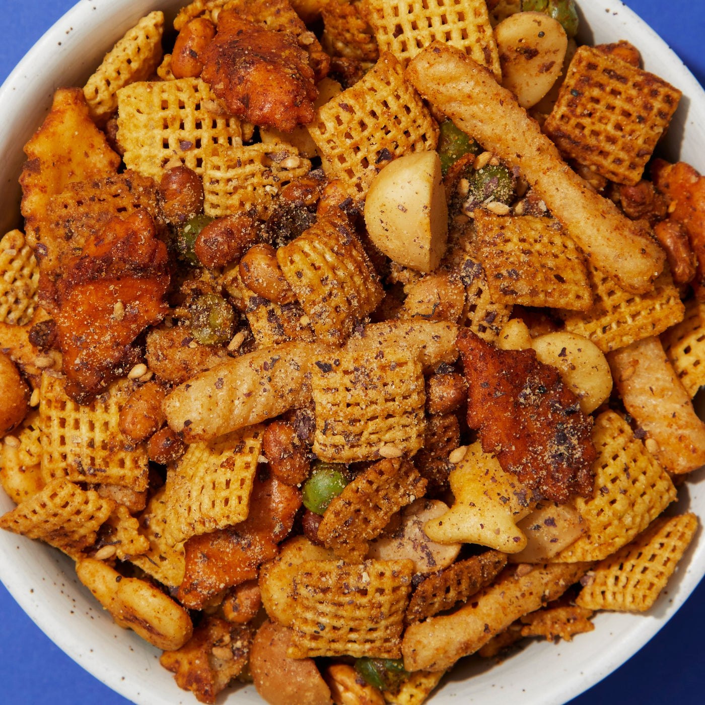 A bowl of snack mix with furikake seasoning. 