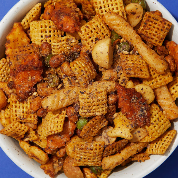 A bowl of snack mix with furikake seasoning. 