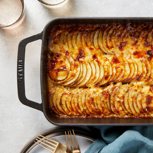 A baking dish of black garlic potatoes au gratin. 
