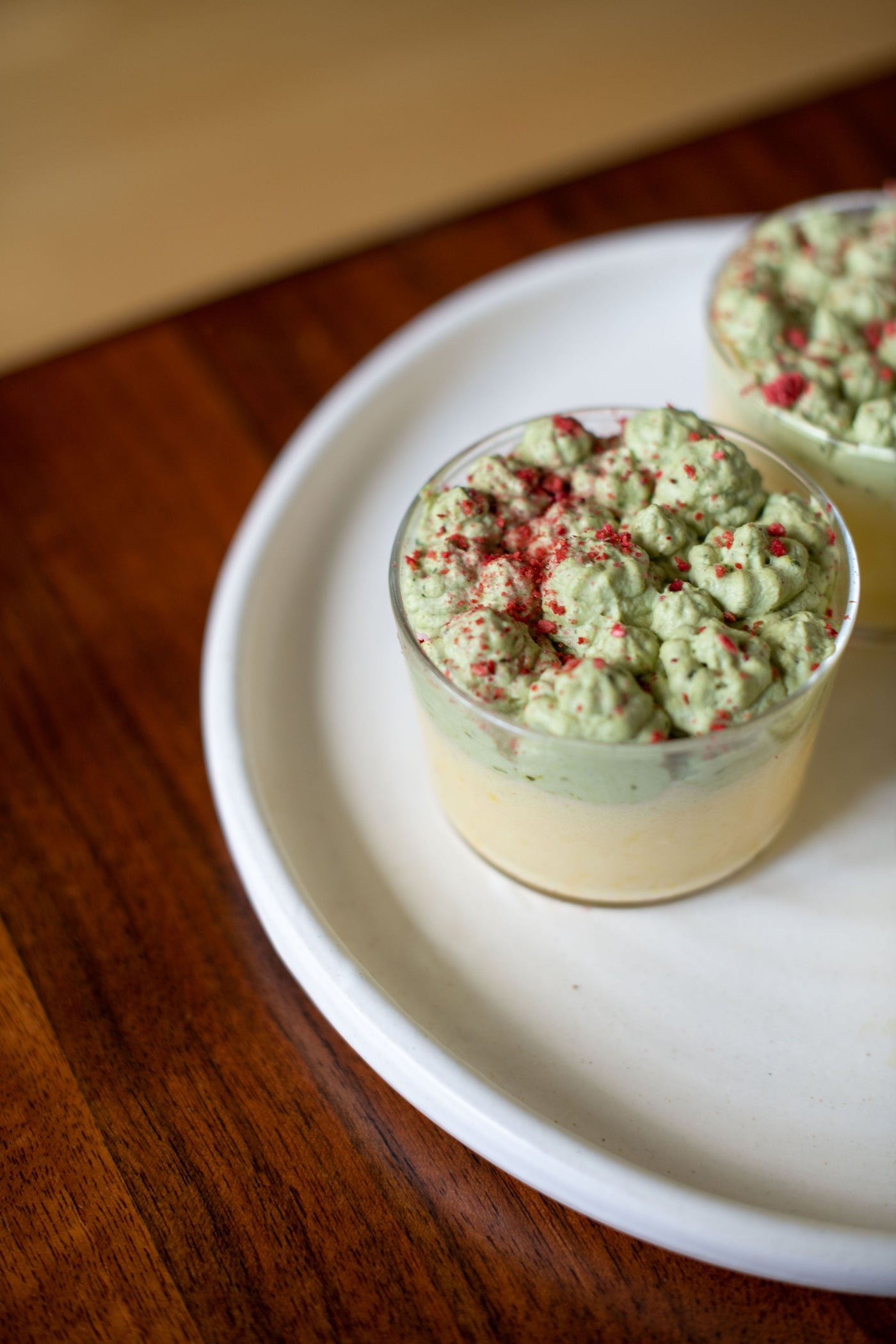 A cup of white chocolate yuzu mousse with matcha whipped cream.