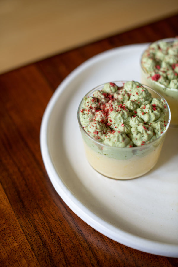 A cup of white chocolate yuzu mousse with matcha whipped cream.