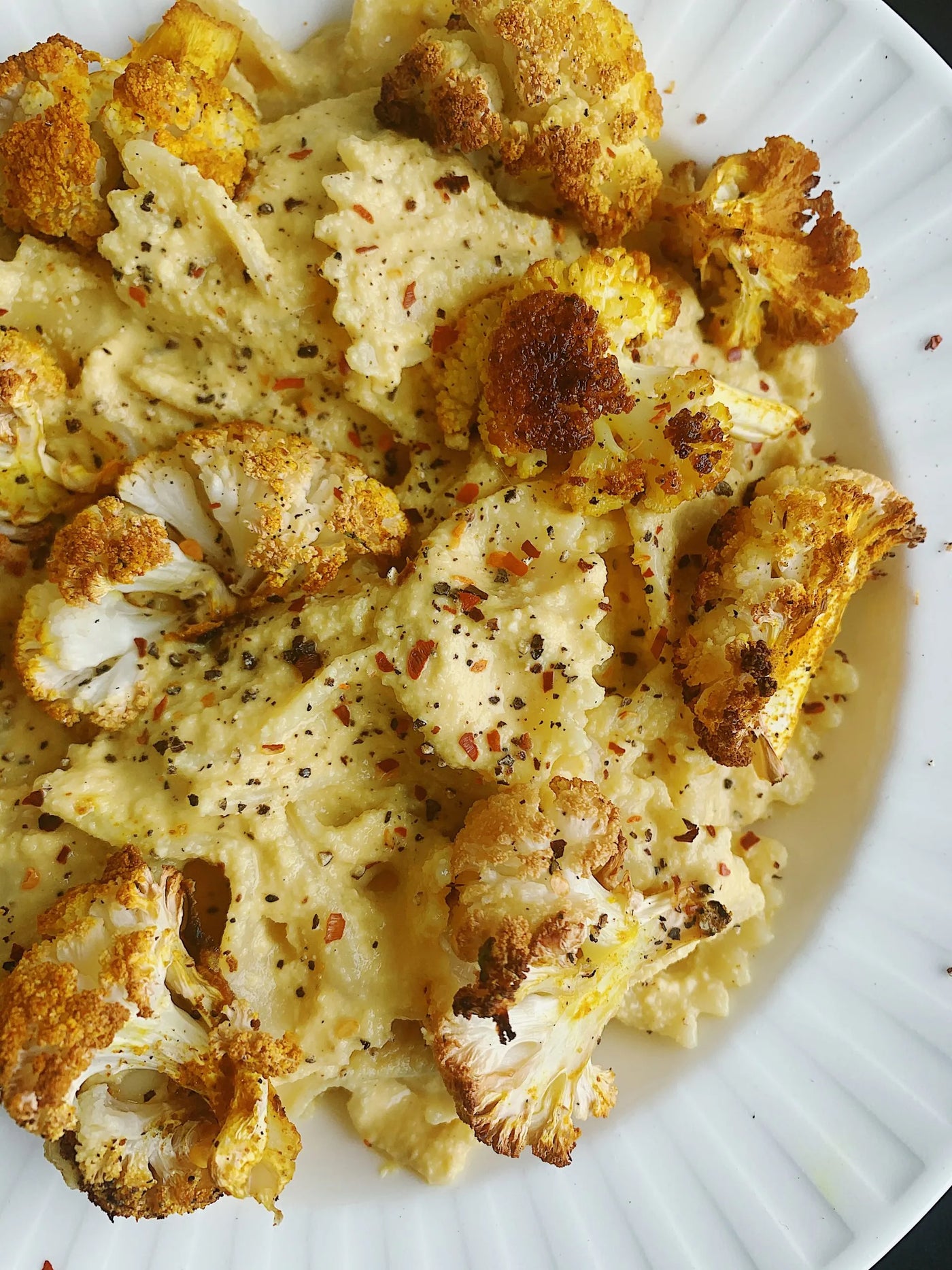 Plate of charred cauliflower and pasta.
