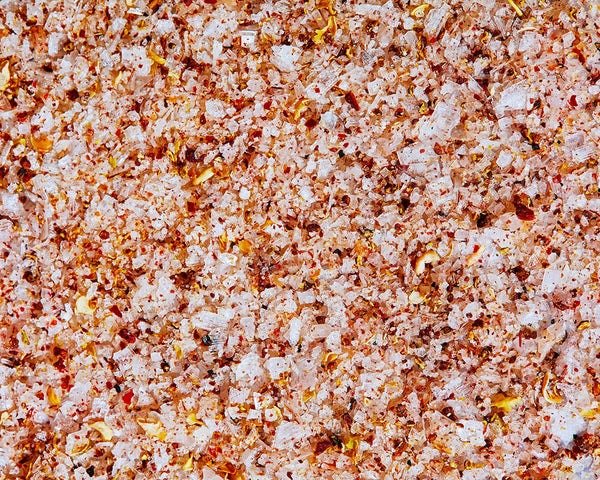 A close-up photo of tingly Sichuan sea salt. There are visible flakes of dry peppers and granules of salt.